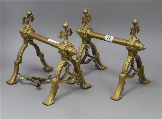 A pair of brass fire dogs in the manner of Christopher Dresser height 24cm